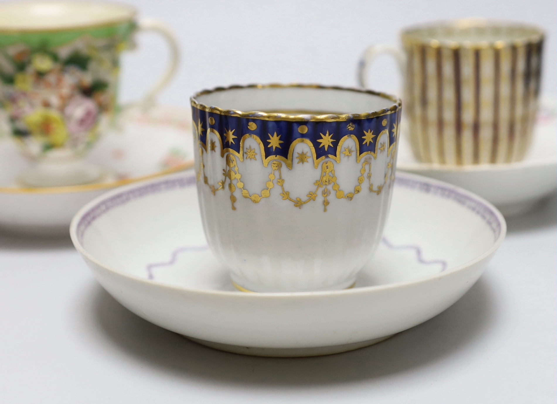 A group of early 19th century English porcelain cups and various saucers to include a Spode two handled chocolate cup and saucer (10)